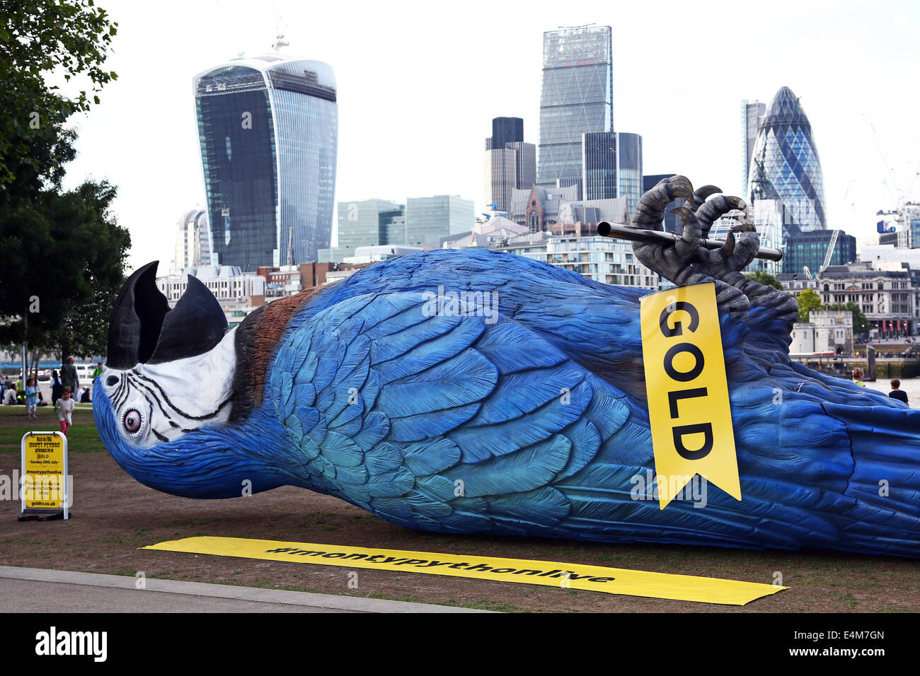 London, UK. 14th July 2014. A giant fibre-glass Dead Parrot almost 50 feet long has been laid on its back at Potter's Field near London Bridge, London to promote Monty Python live on the TV channel Gold. It is a replica of the mythical Norwegian Blue which is the subject of one of the most famous Monty Python sketches. Credit:  Paul Brown/Alamy Live News Stock Photo