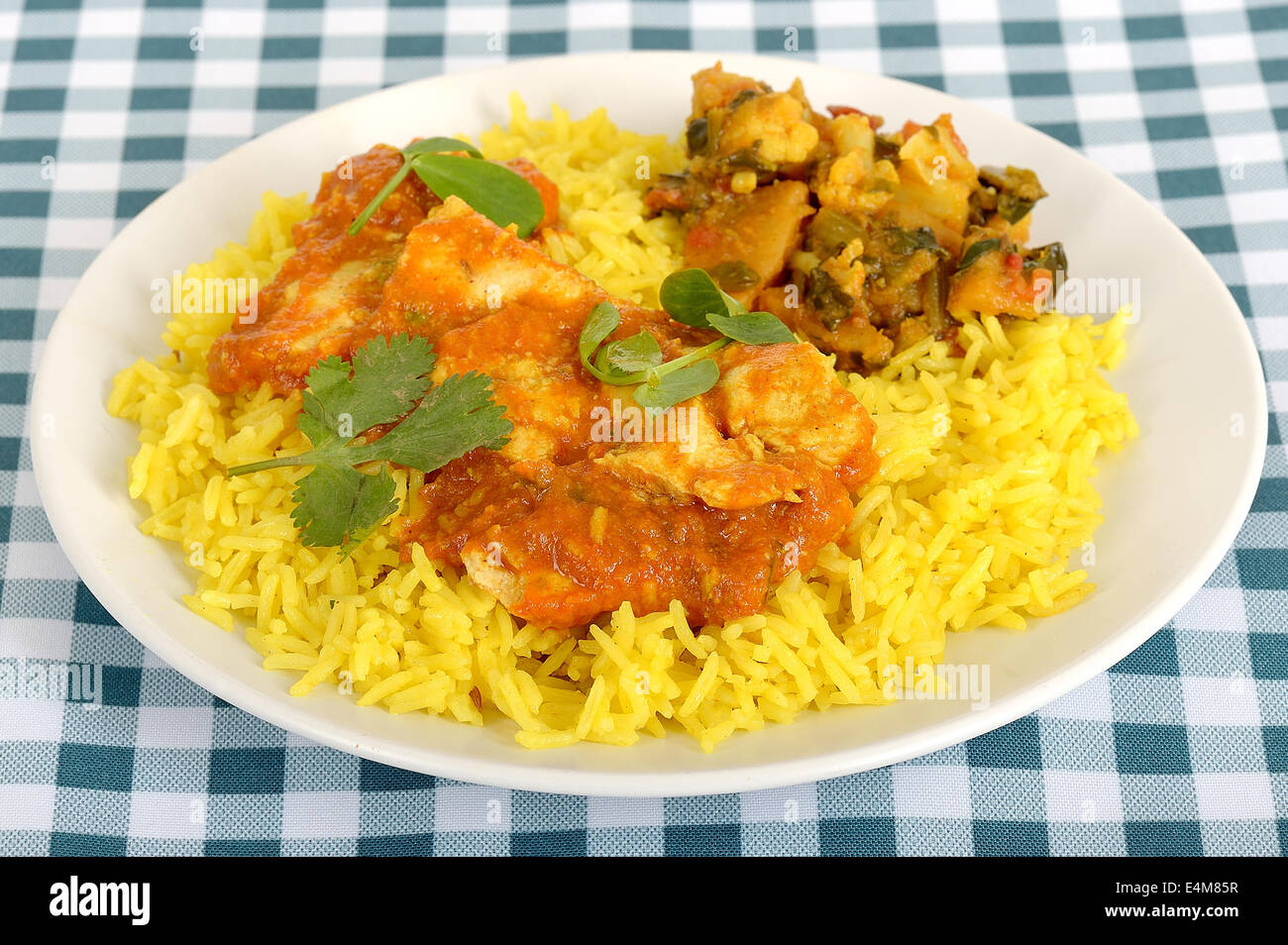 Freshly Prepared Authentic Indian Style Spicy Chicken Madras Curry With Yellow Pilau Rice Meal Isolated Against A White Background With No People Stock Photo