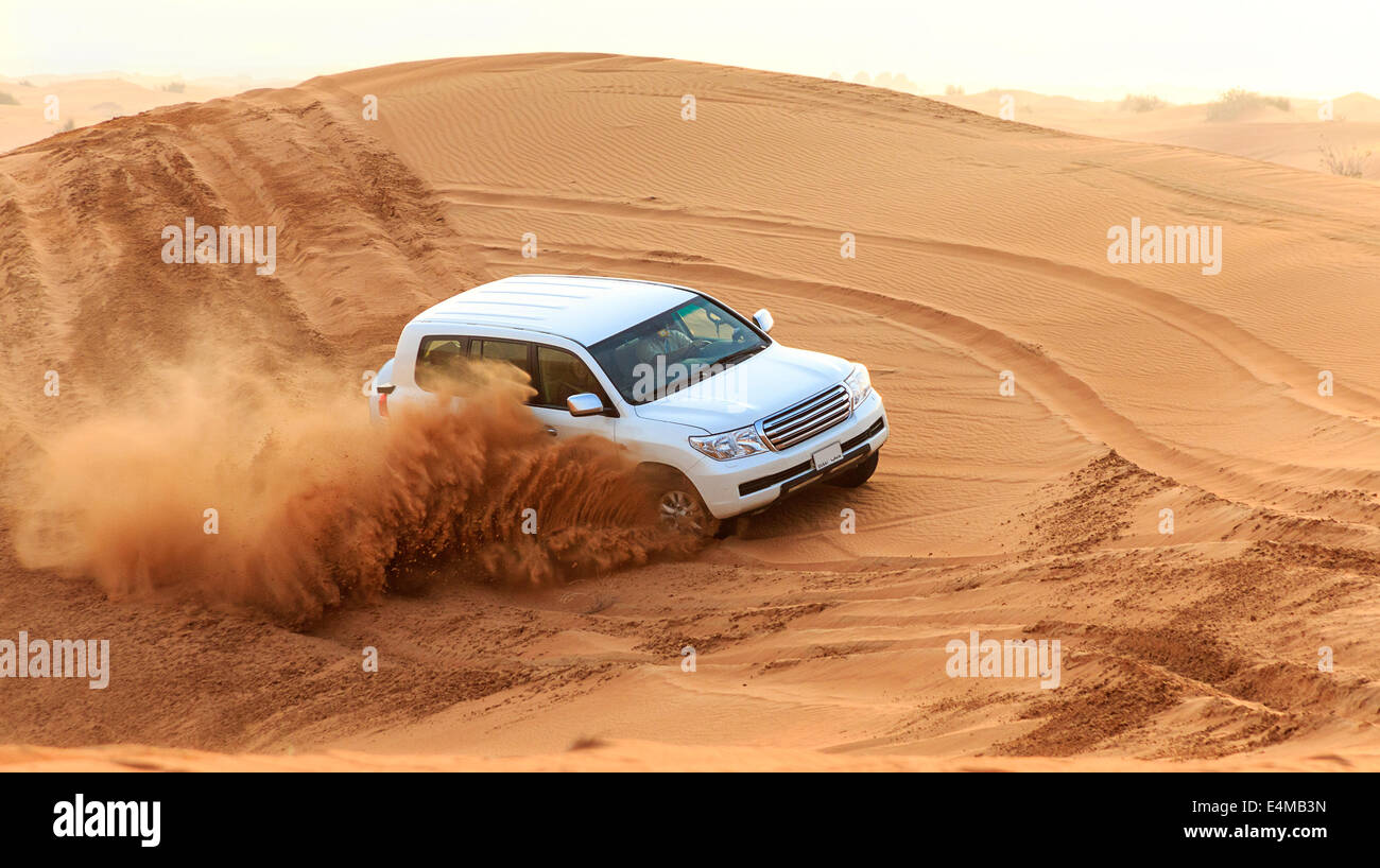 Dune bashing among the sand dunes outside Dubai, UAE. No brand logos on car or license tag numbers Stock Photo