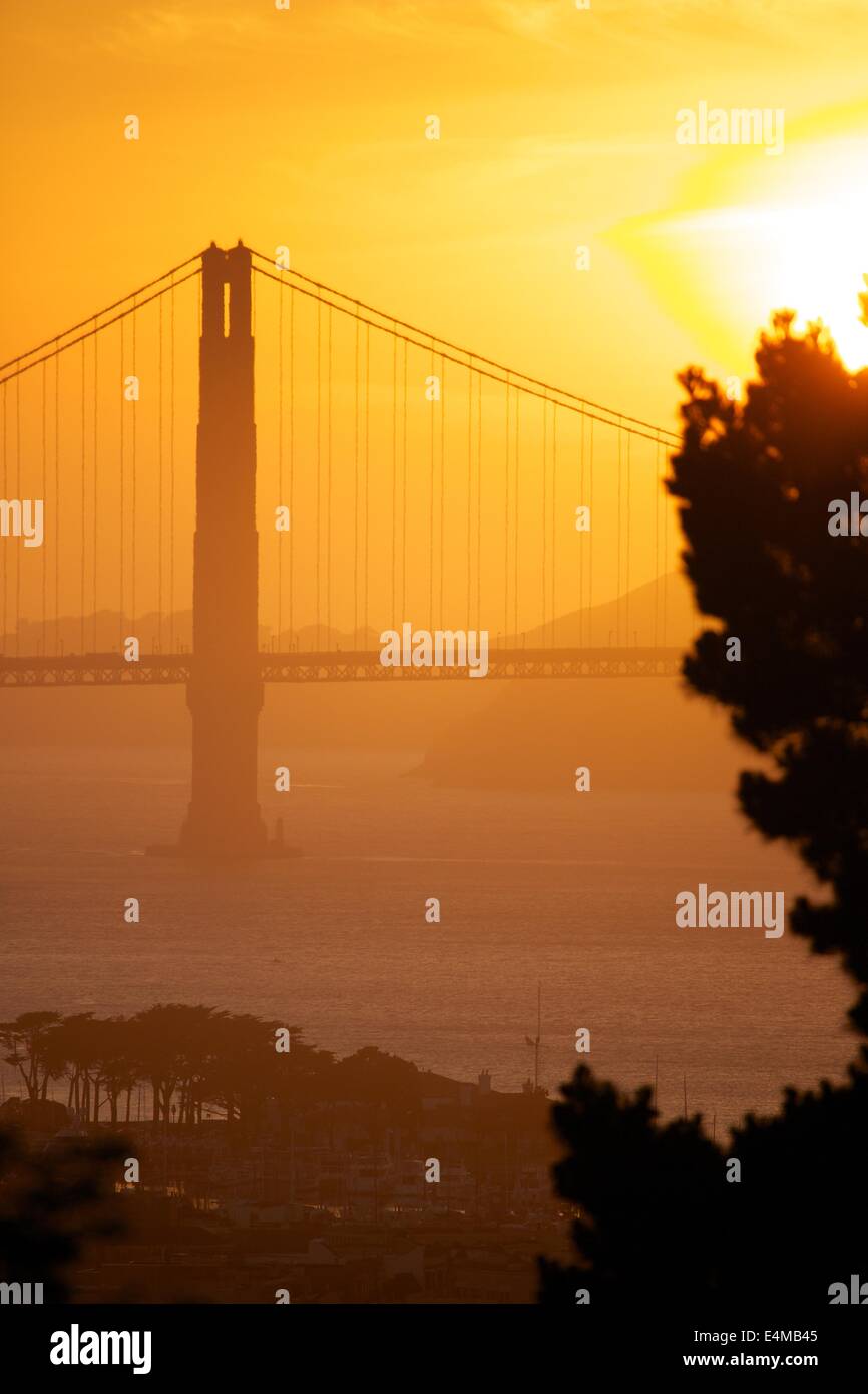 Glowing orange sunset behind the Golden Gate Bridge in San Francisco, California Stock Photo