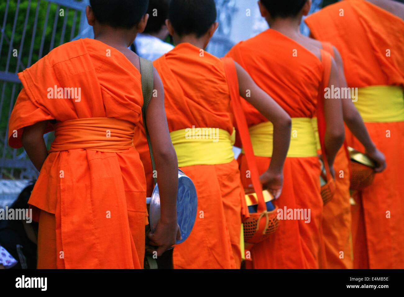 Buddhist monks in Luang Prabang, Laos make their morning ritual collecting rice Stock Photo