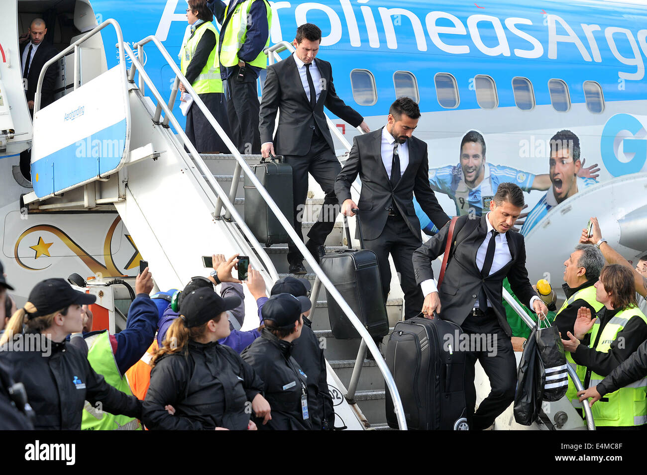 Ezeiza, Argentina. 14th July, 2014. Lionel Messi (Top), Ezequiel Lavezzi (C) and Martin Demichelis (Bottom) of Argentina National Team descend of the plane in the Minister Pistarini International Airport, in the city of Ezeiza, Argentina, on July 14, 2014. Argentina National Team returned after won the silver in the 2014 FIFA World Cup Brazil. Credit:  Leonardo Zavattaro/TELAM/Xinhua/Alamy Live News Stock Photo