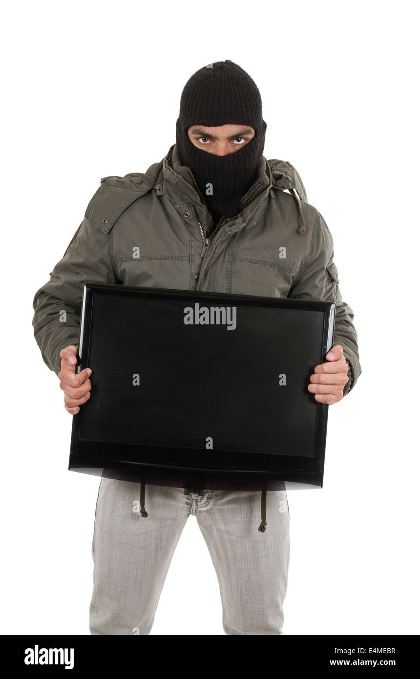 young thief wearing black hood and jacket Stock Photo