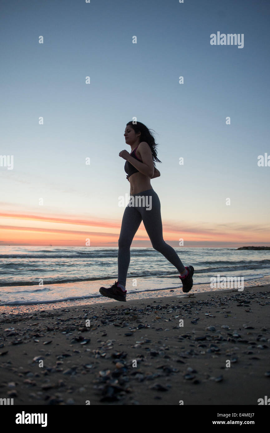 Young Girl Running On The Beach Stock Photo - Alamy