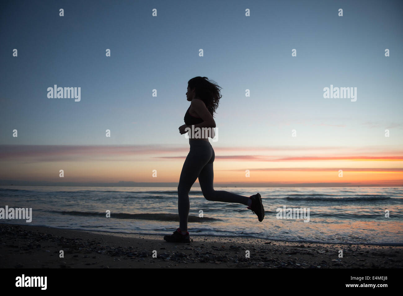 Young Girl Running On The Beach Stock Photo - Alamy