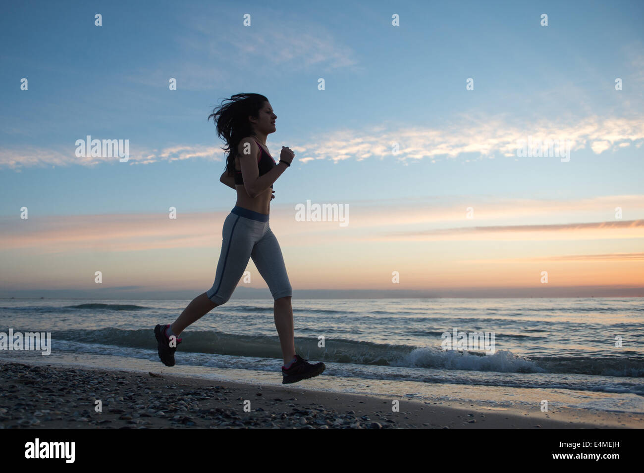 Young Girl Running On The Beach Stock Photo - Alamy