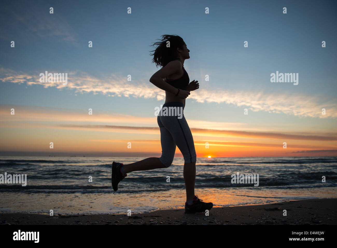Young Girl Running On The Beach Stock Photo - Alamy