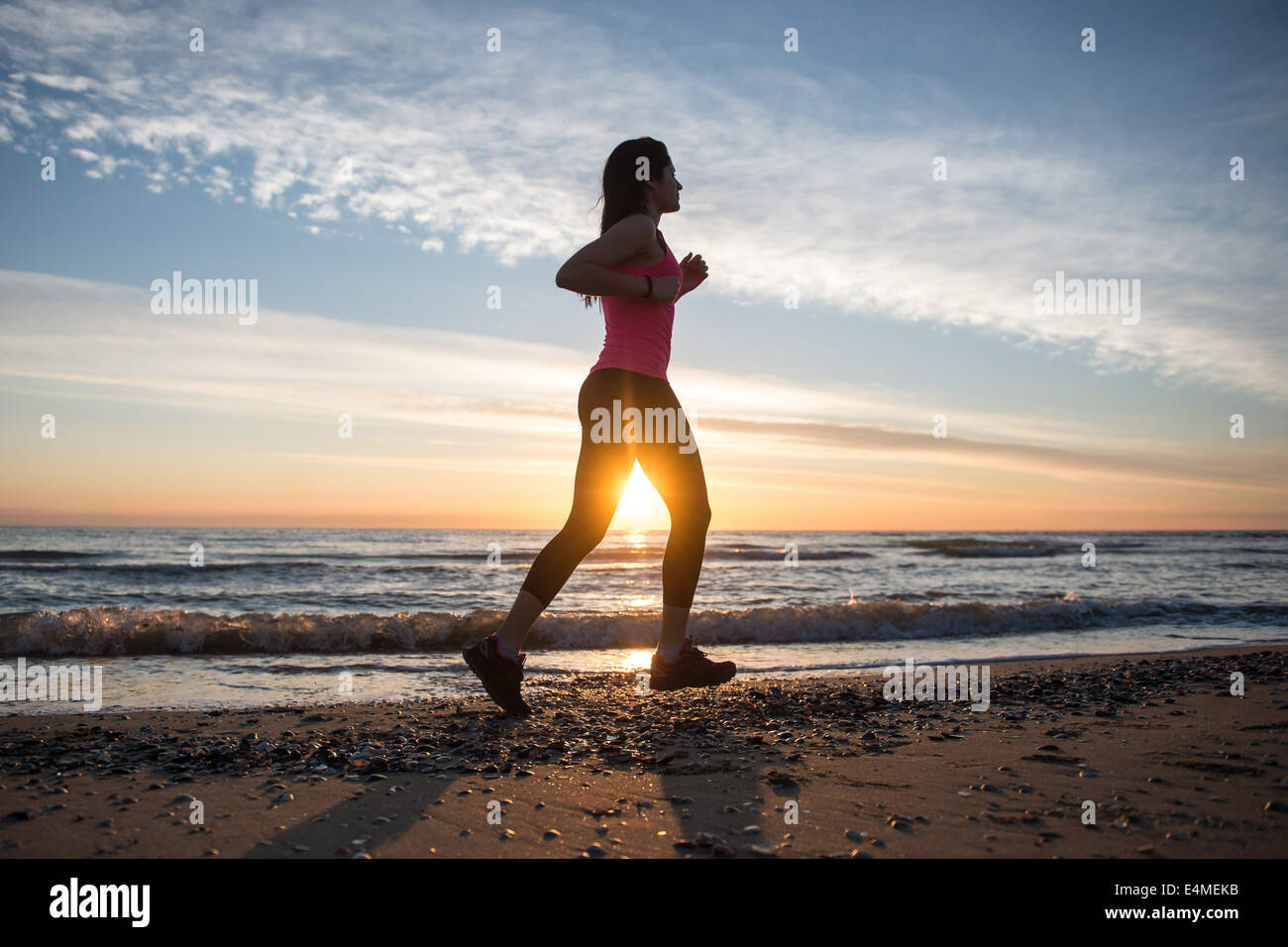 Young Girl Running On The Beach Stock Photo - Alamy