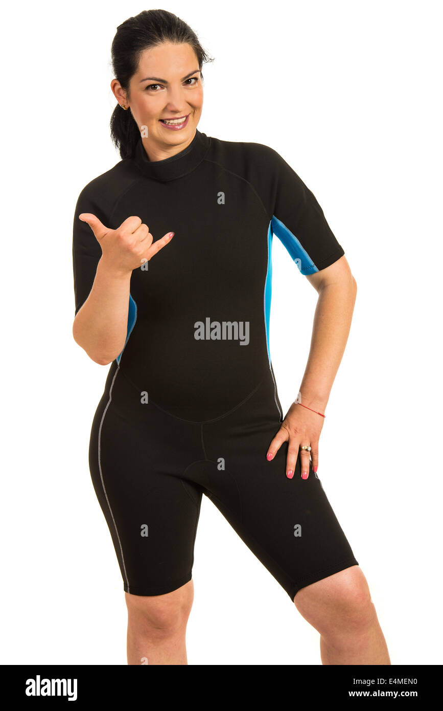 Happy surfer woman in neoprene suit giving hang loose sign isolated on white background Stock Photo