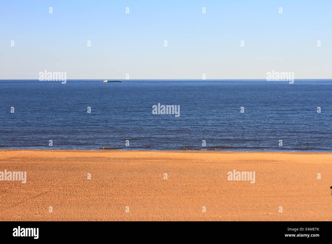 Gorleston beach in afternoon, Sand sea sky,3 layers, sea,north sea, cargo ship, Stock Photo