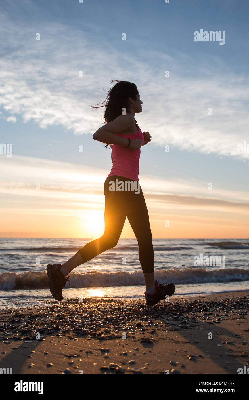 Young Girl Running On The Beach Stock Photo - Alamy