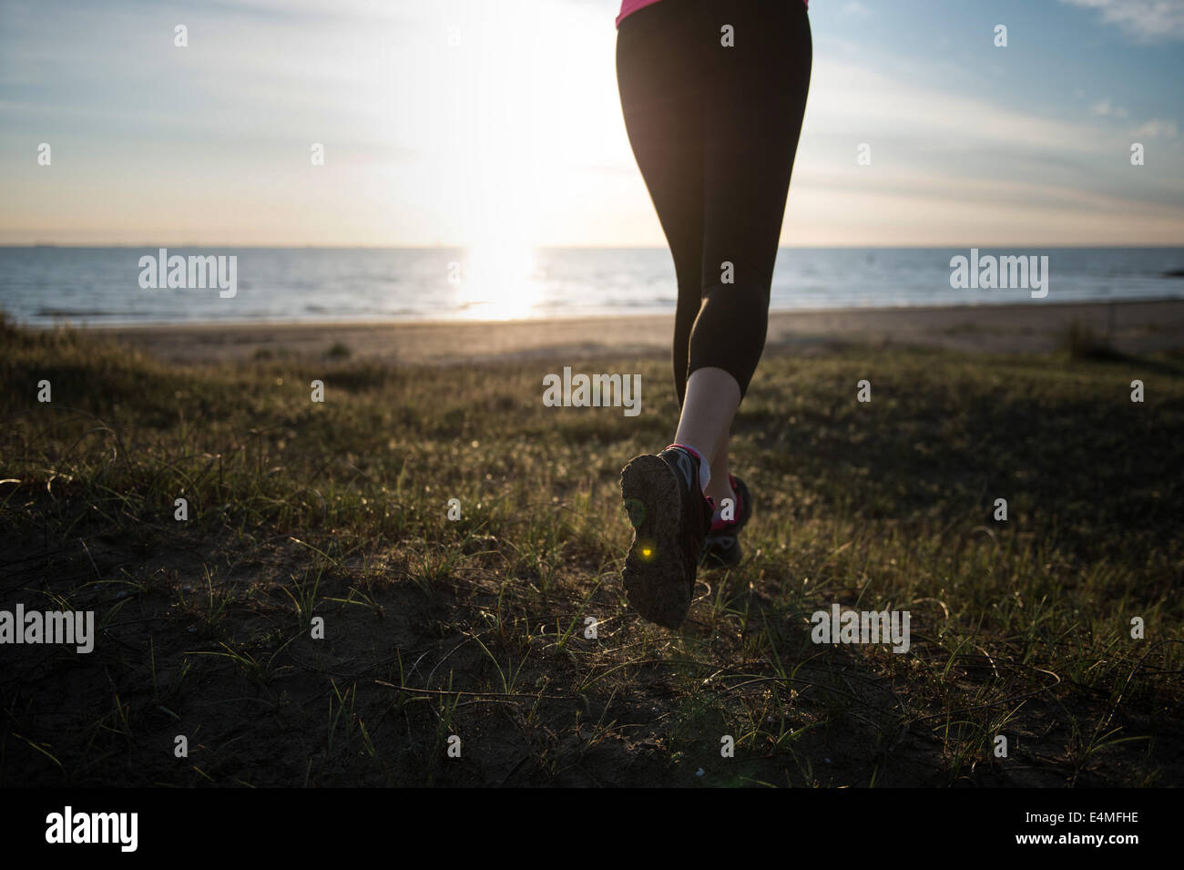 Young Girl Running On The Beach Stock Photo - Alamy