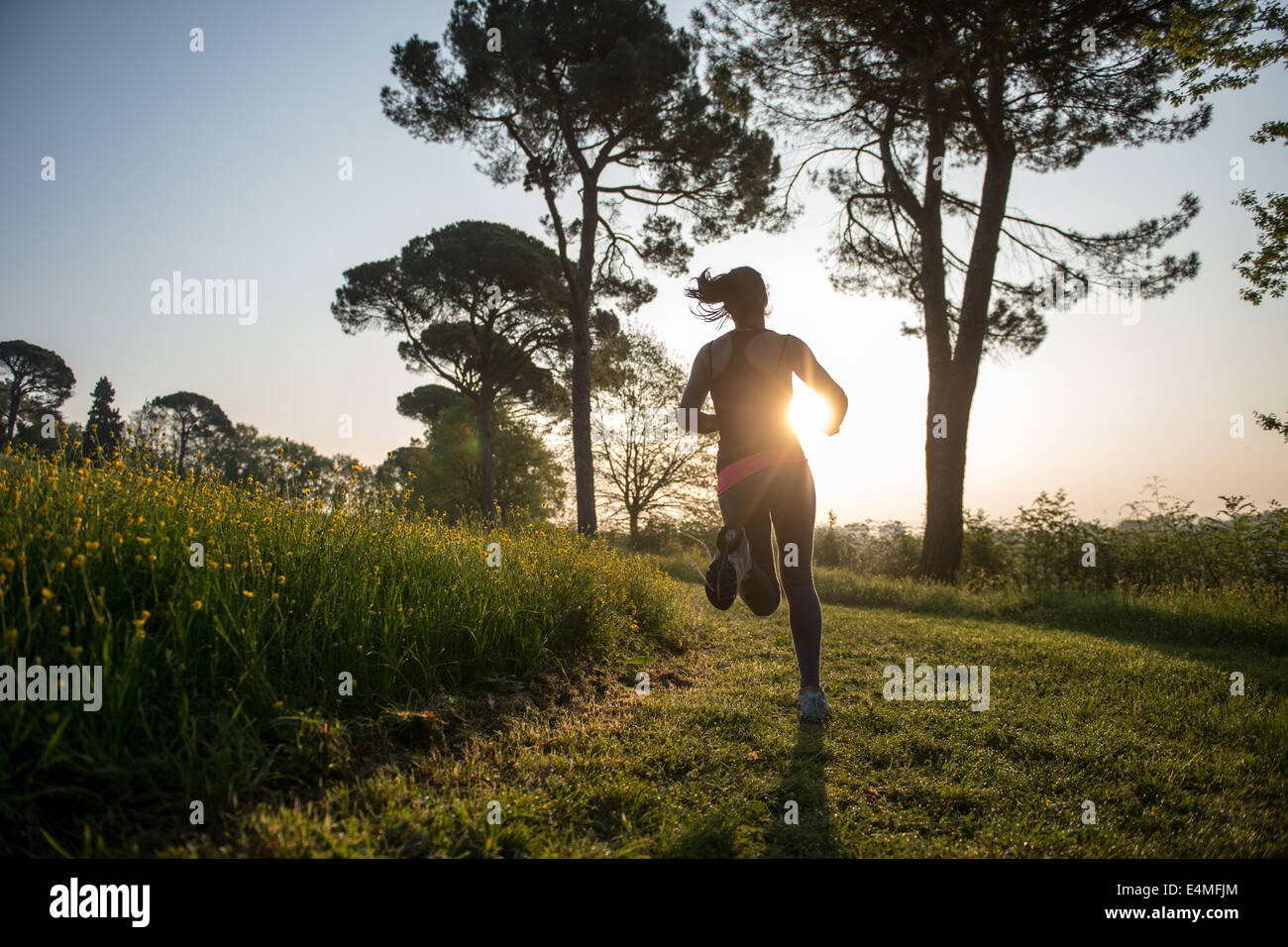 Young Girl Running In A Park Stock Photo