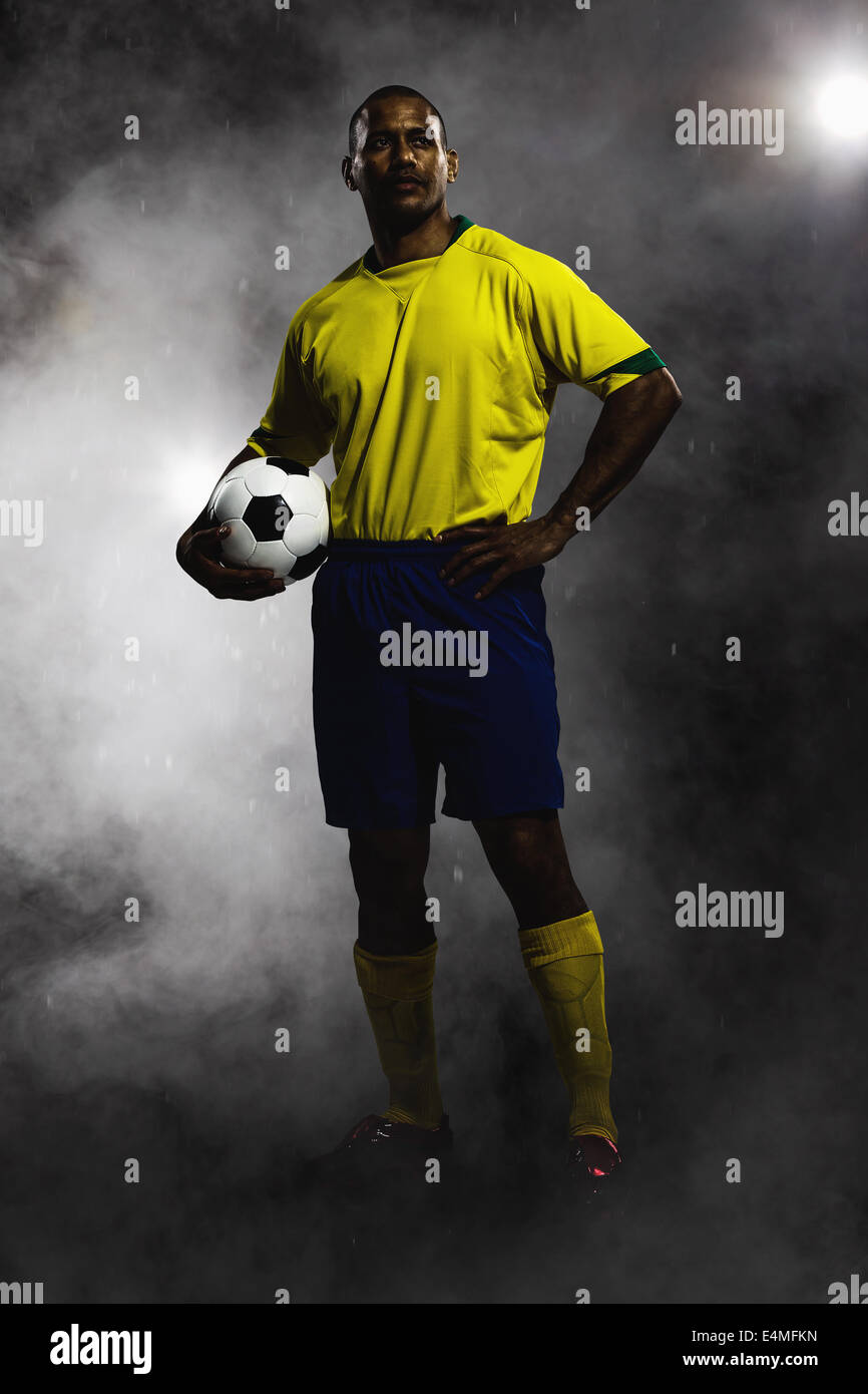 Soccer Player Standing With Ball Stock Photo