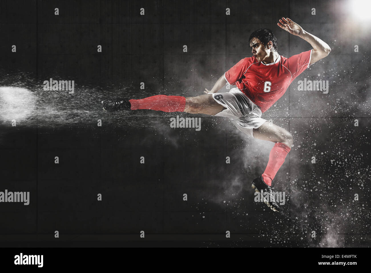 Soccer Player Kicking The Ball In MidAir Stock Photo Alamy