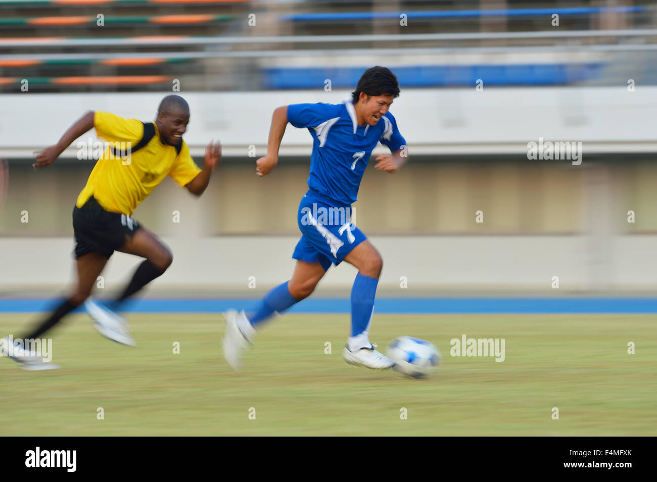 Football players running with ball Stock Photo Alamy