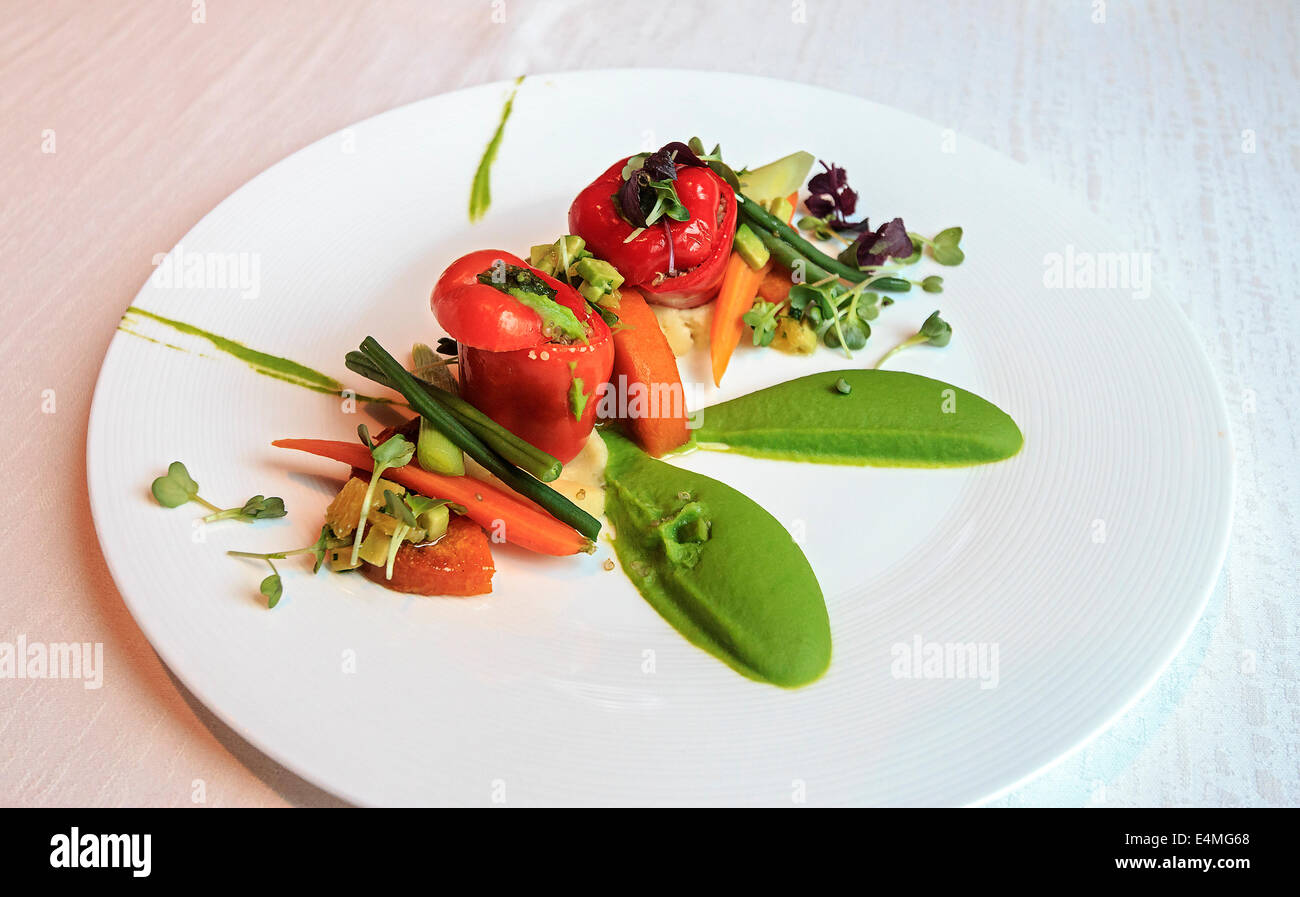 Vegetable appetizer with warm butternut squash and bell peppers along with pureed peas and avocado deluxe restaurant in Dubai Stock Photo
