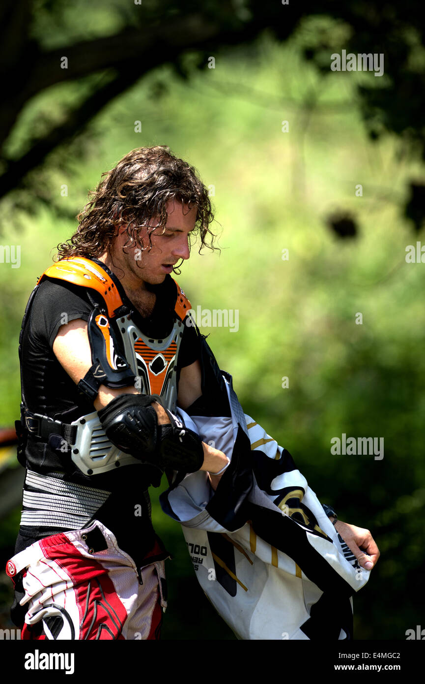 Young Man Relaxing After Riding Dirt Bike Stock Photo