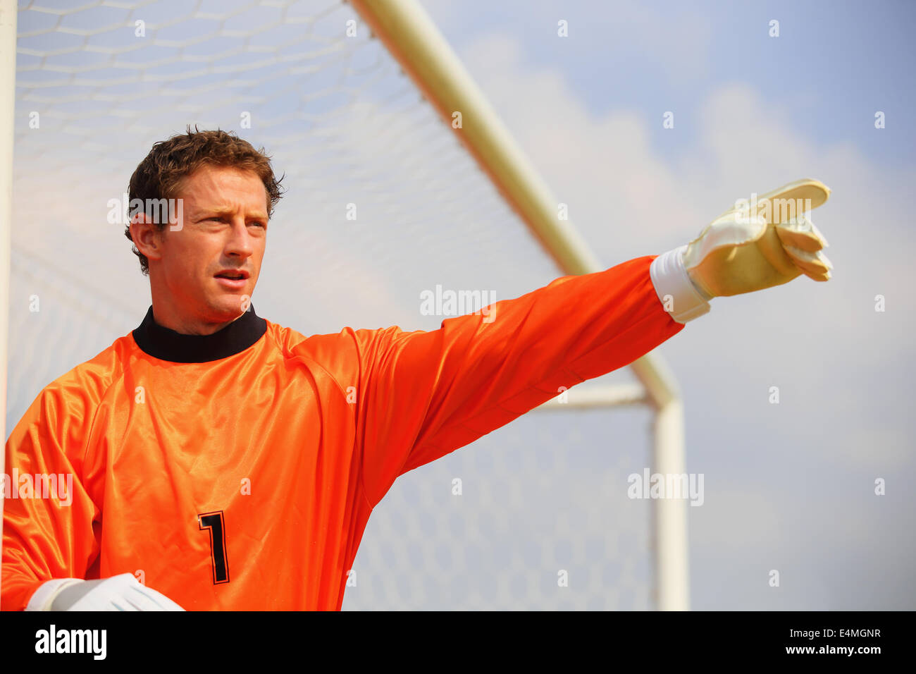 Goalkeeper in orange uniform Stock Photo