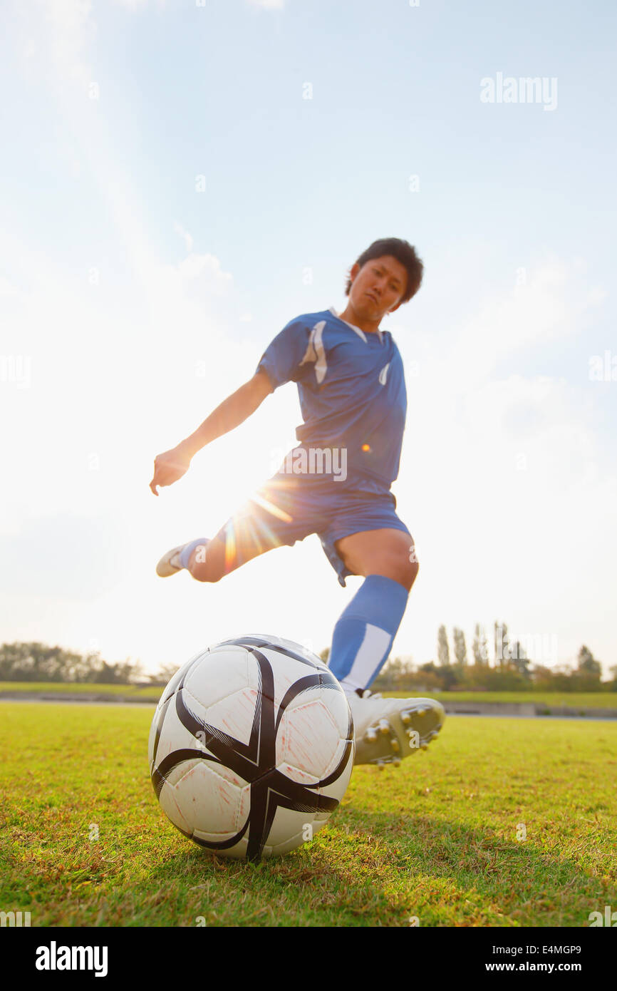 Football player kicking ball Stock Photo Alamy