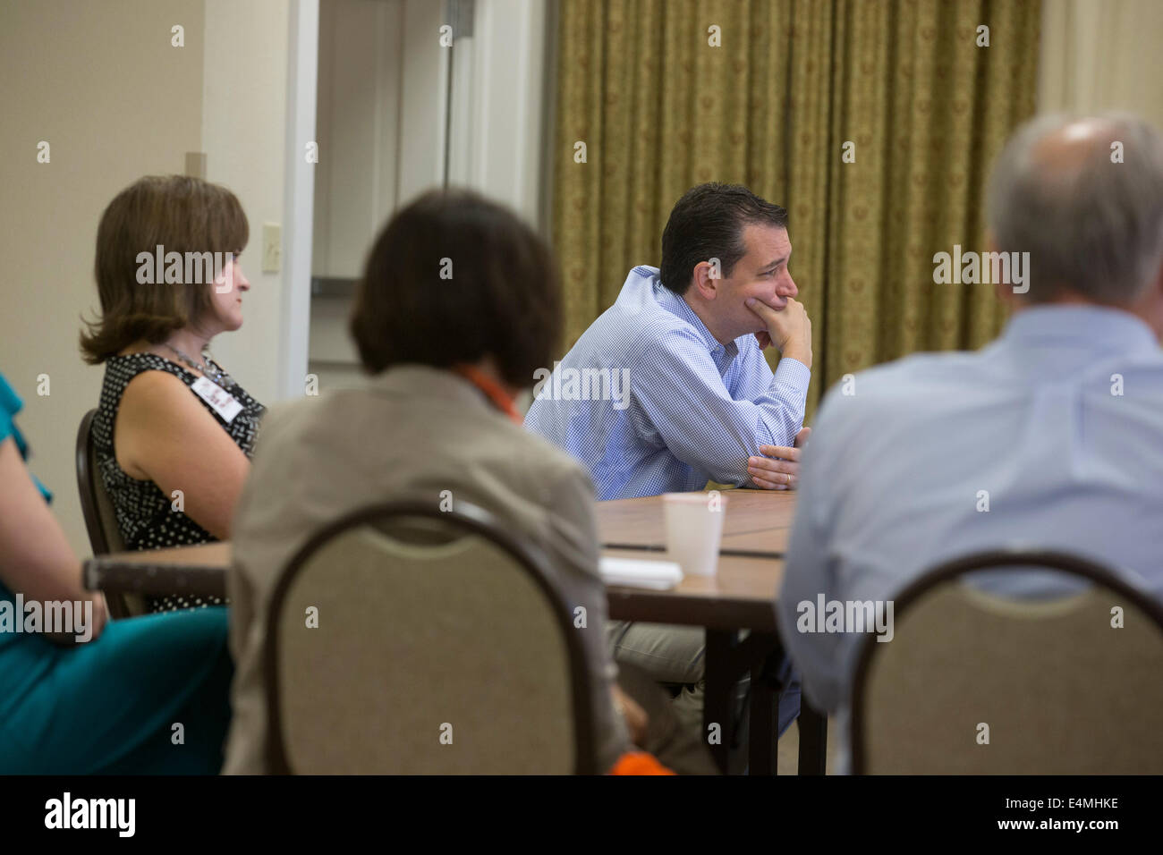 Republican U.S. Senator Ted Cruz  (center) listens to constituents in the central Texas town of Fredericksburg. Stock Photo