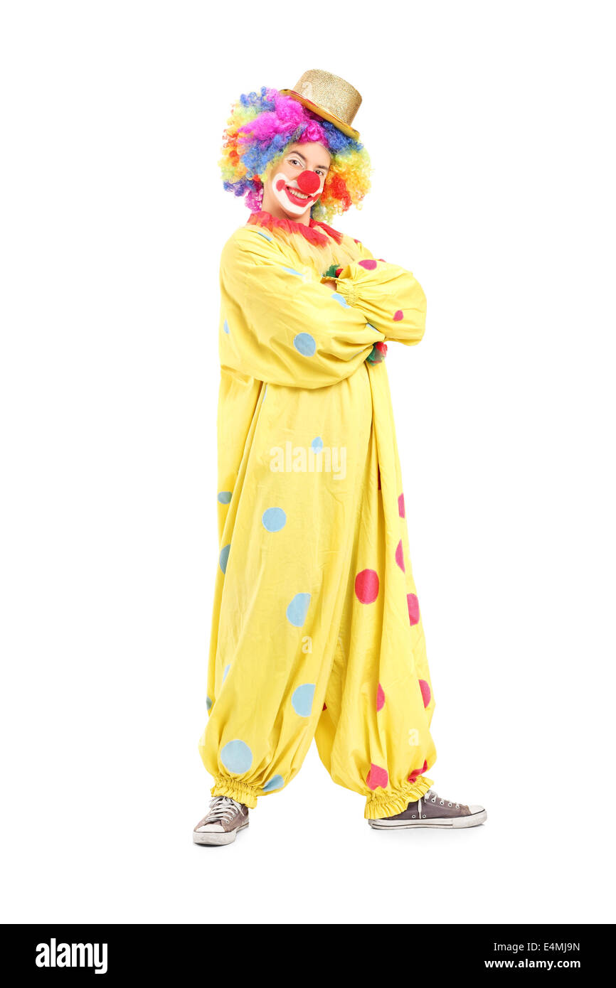 Full length portrait of a funny male clown in a yellow costume Stock Photo