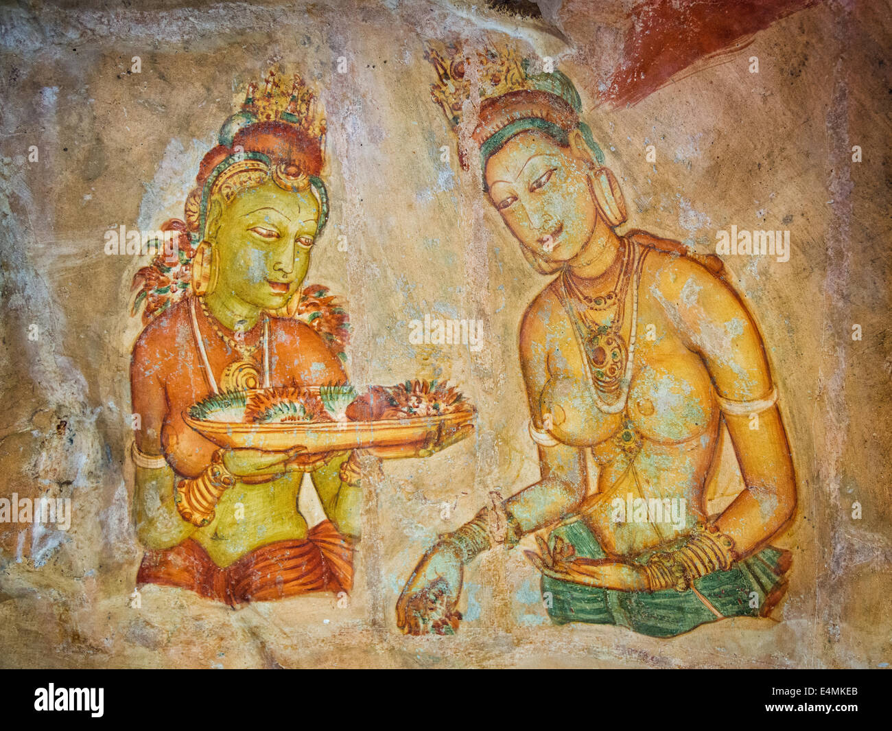 Ancient frescoes of apsaras in a niche against the rock of Sigiriya Stock Photo