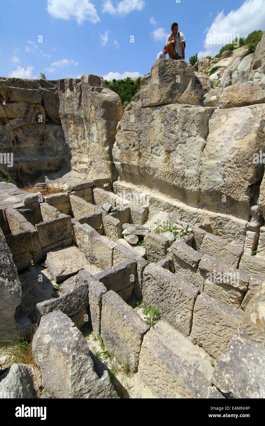 Perperikon, BGR. 13th July, 2014. People attend at the Thracian ancient monumental archaeological complex Perperikon south-east of the Bulgarian capital Sofia, Sunday, July, 13, 2014. Perperikon is one of the most ancient monumental megalithic structures, entirely carved into the rocks as is one of the most popular tourist destinations in Bulgaria. Religious activity at the top of the cliff began in the 5th century BC. It is associated with the beliefs of the Copper Age people, who started the cult of the sun god. Here they established the first sanctuary and started leaving food containers f Stock Photo