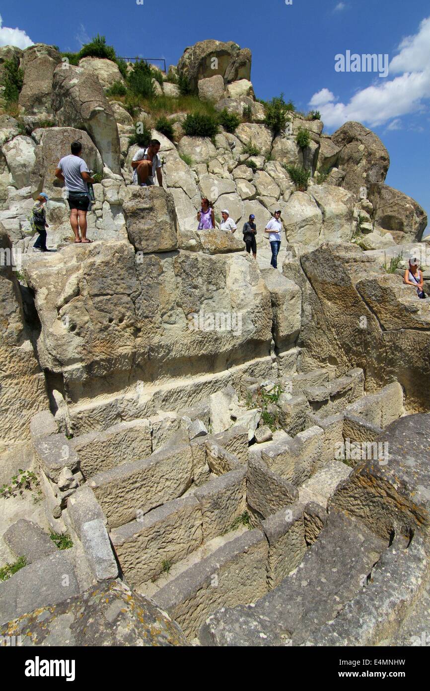 Perperikon, BGR. 13th July, 2014. People attend at the Thracian ancient monumental archaeological complex Perperikon south-east of the Bulgarian capital Sofia, Sunday, July, 13, 2014. Perperikon is one of the most ancient monumental megalithic structures, entirely carved into the rocks as is one of the most popular tourist destinations in Bulgaria. Religious activity at the top of the cliff began in the 5th century BC. It is associated with the beliefs of the Copper Age people, who started the cult of the sun god. Here they established the first sanctuary and started leaving food containers f Stock Photo