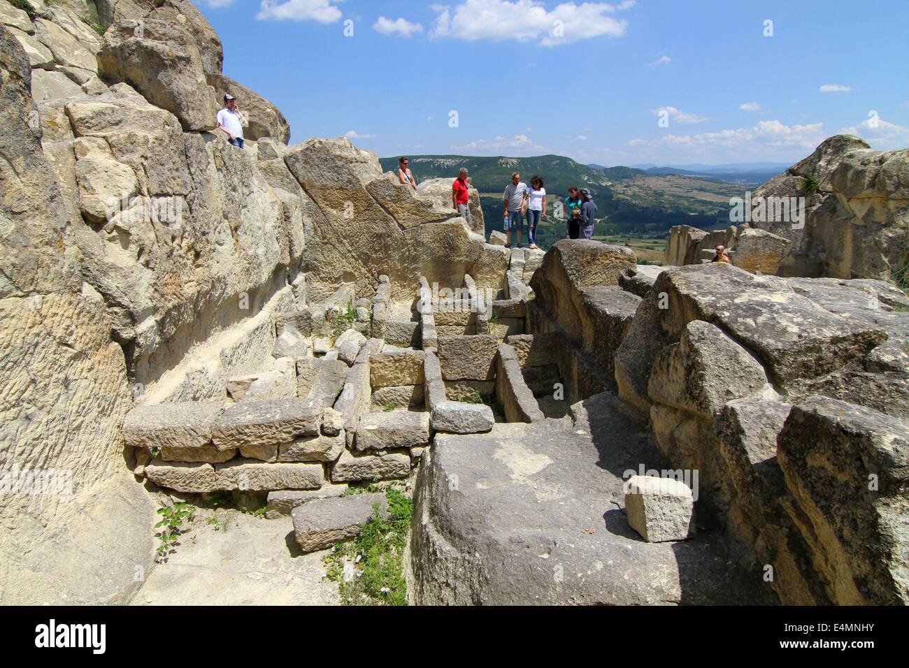 July 13, 2014 - Perperikon, BGR - People attend at the Thracian ancient monumental  archaeological complex Perperikon south-east of the Bulgarian capital Sofia, Sunday, July, 13, 2014. Perperikon is one of the most ancient monumental megalithic structures, entirely carved into the rocks as is one of the most popular tourist destinations in Bulgaria. Religious activity at the top of the cliff began in the 5th century BC. It is associated with the beliefs of the Copper Age people, who started the cult of the sun god. Here they established the first sanctuary and started leaving food containers f Stock Photo