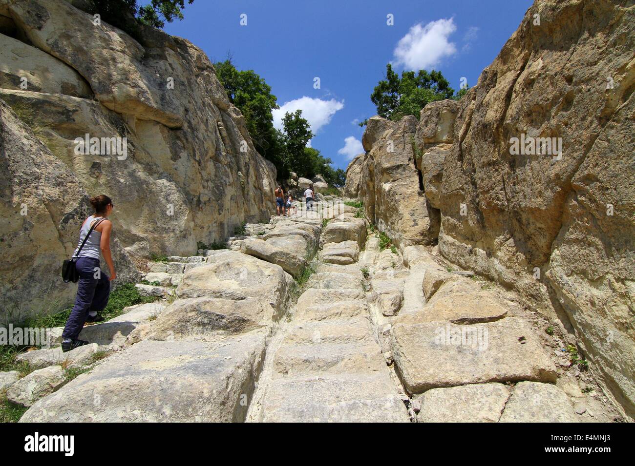 July 13, 2014 - Perperikon, BGR - People attend at the Thracian ancient monumental  archaeological complex Perperikon south-east of the Bulgarian capital Sofia, Sunday, July, 13, 2014. Perperikon is one of the most ancient monumental megalithic structures, entirely carved into the rocks as is one of the most popular tourist destinations in Bulgaria. Religious activity at the top of the cliff began in the 5th century BC. It is associated with the beliefs of the Copper Age people, who started the cult of the sun god. Here they established the first sanctuary and started leaving food containers f Stock Photo