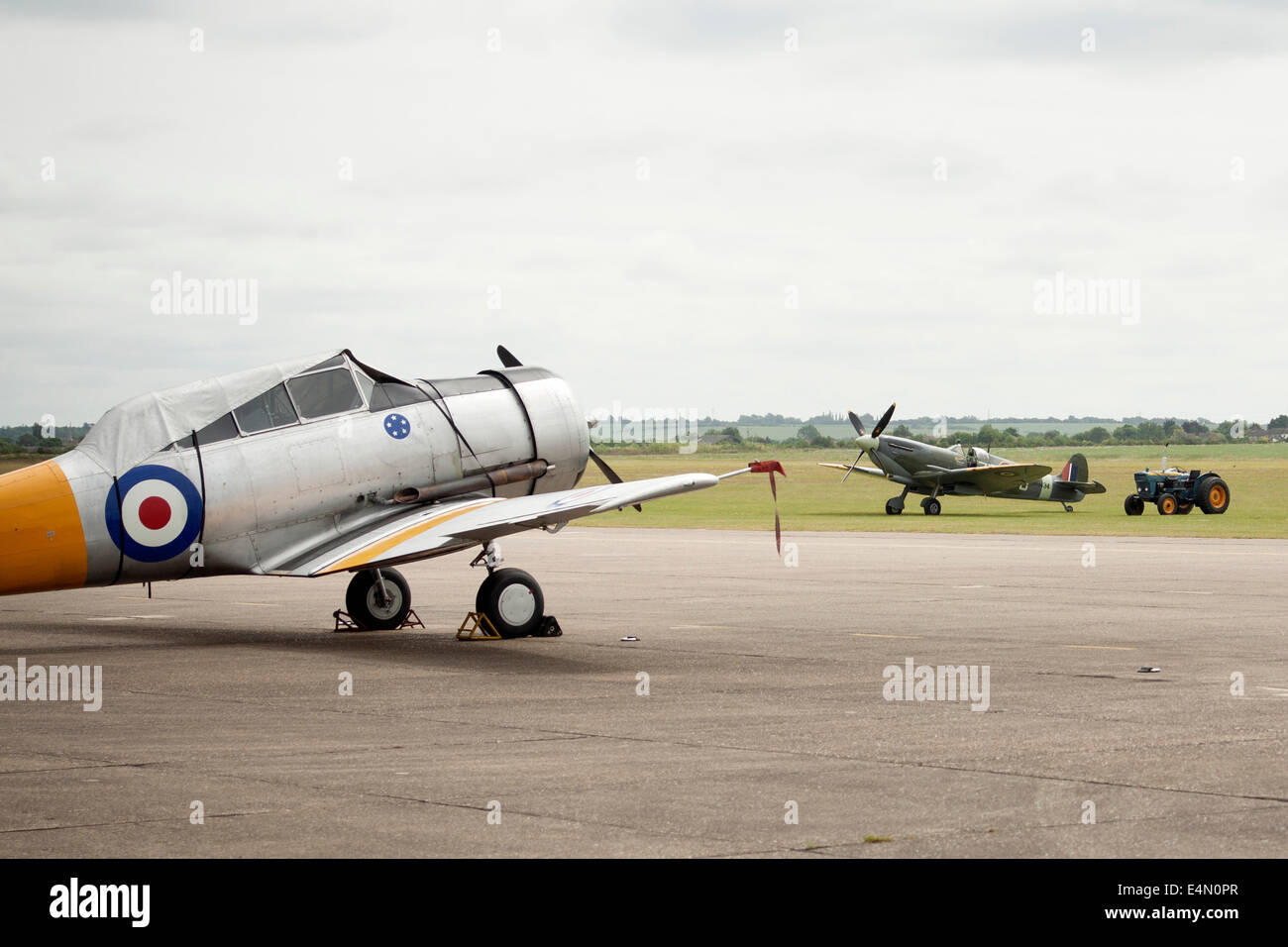 Harvard Trainer and Supermarine Spitfire on the edge of the runway at Duxford Imperial War Museum, United Kingdom Stock Photo