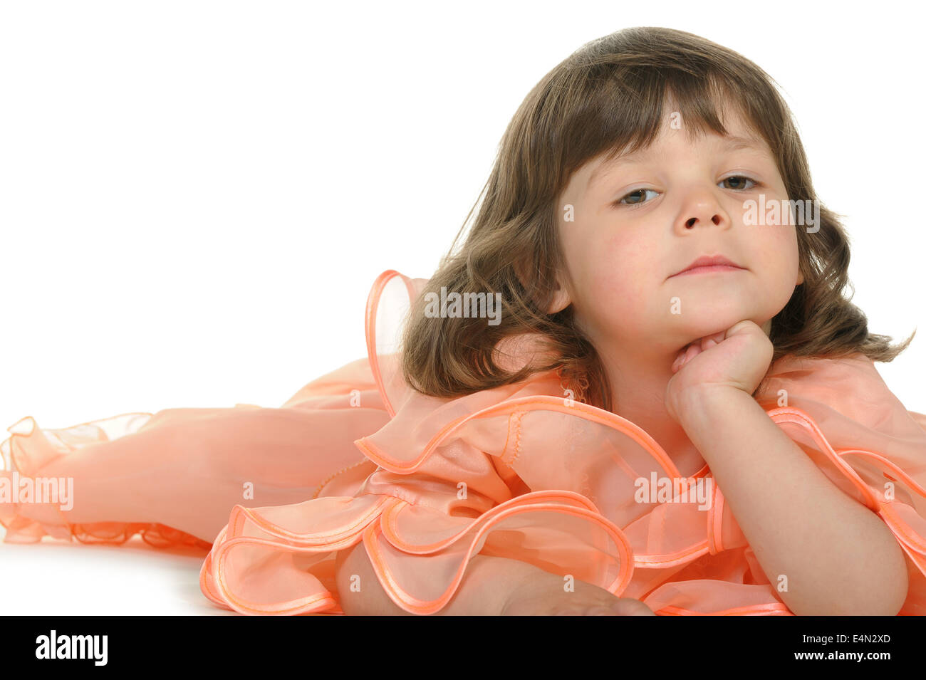 Pretty the little girl lies on the white Stock Photo - Alamy