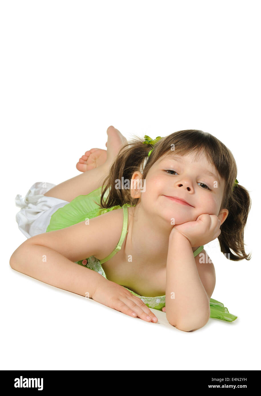 Pretty the little girl lies on the white Stock Photo - Alamy