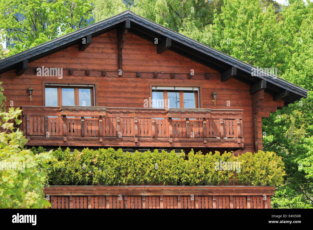 Wooden chalet among summer trees Stock Photo