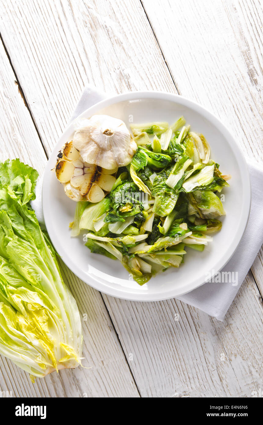 baked Romaine lettuce with garlic and pine cores Stock Photo - Alamy