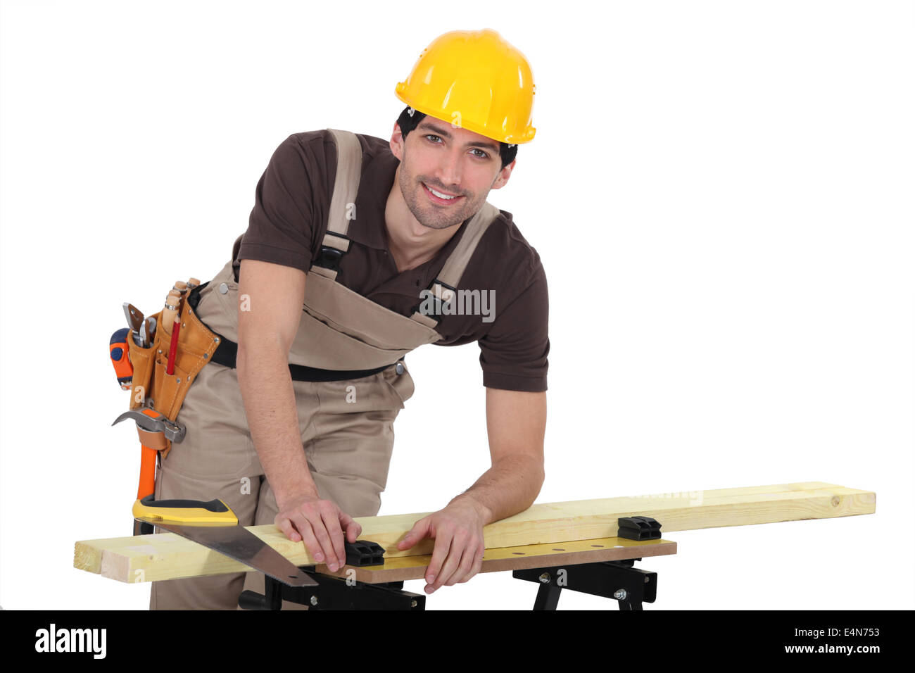 carpenter sawing a plank Stock Photo