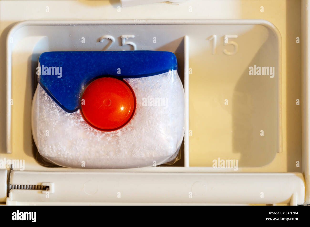 Finish Powerball Quantum Power Gel dishwasher tablet in soap compartment of dishwasher. Stock Photo