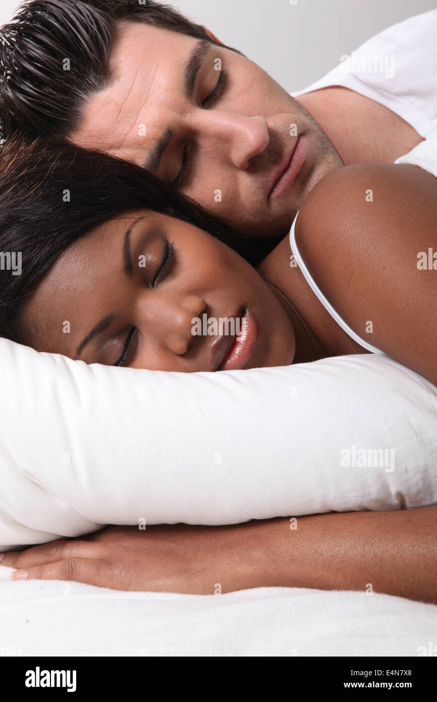 Mixed-race couple asleep Stock Photo