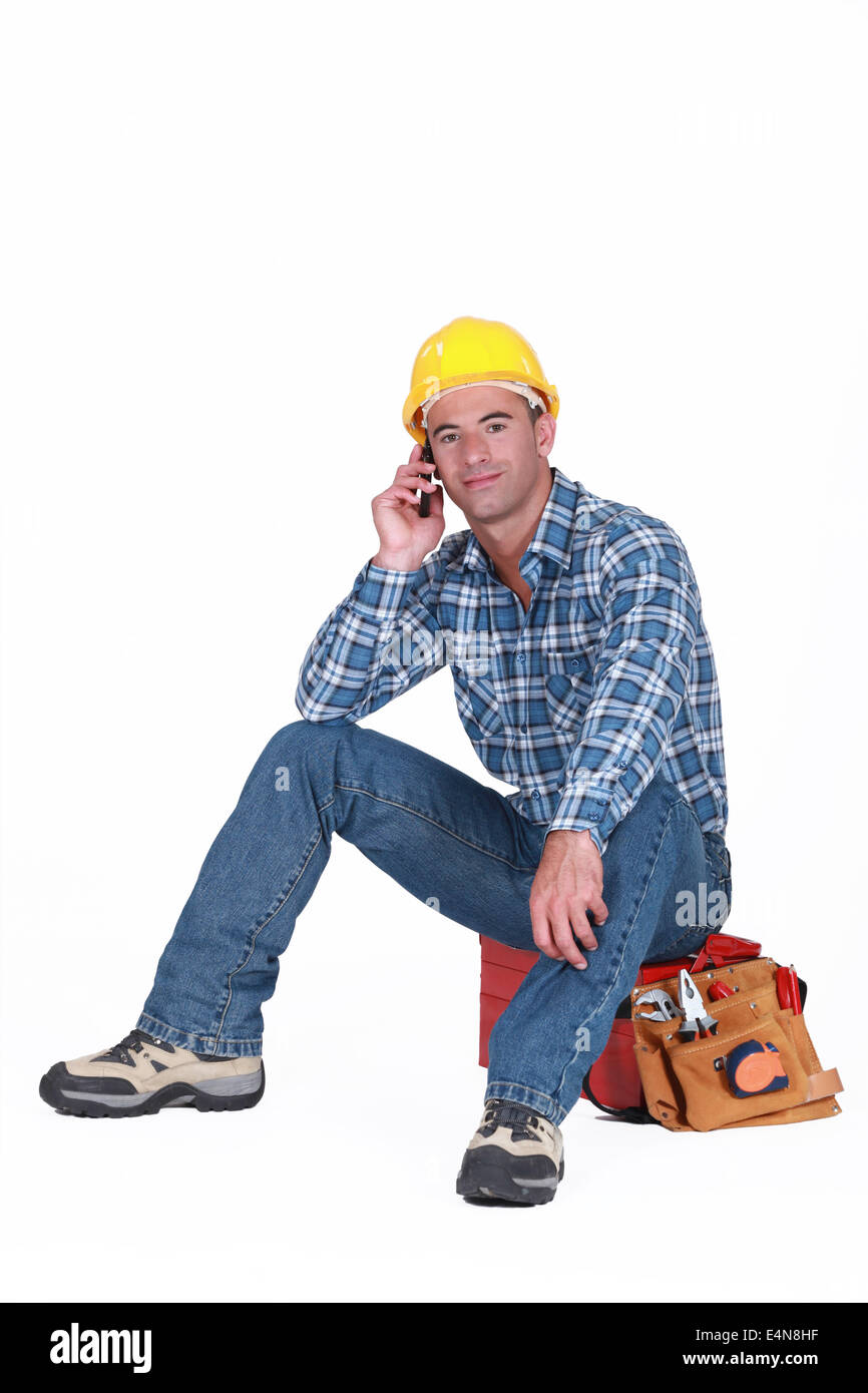 young tradesman on the phone with customer Stock Photo