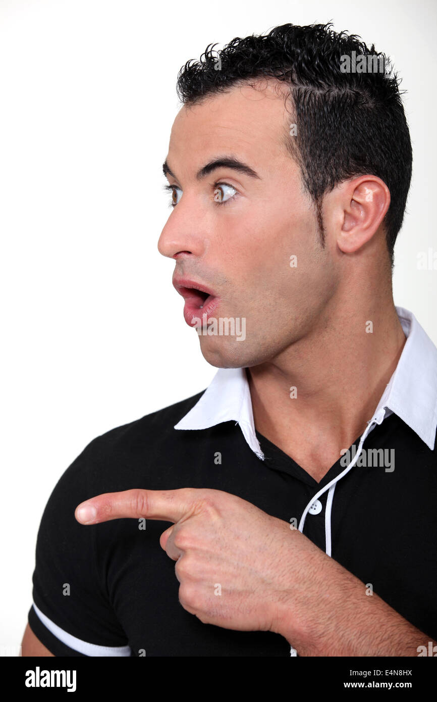 surprised man pointing at something Stock Photo - Alamy