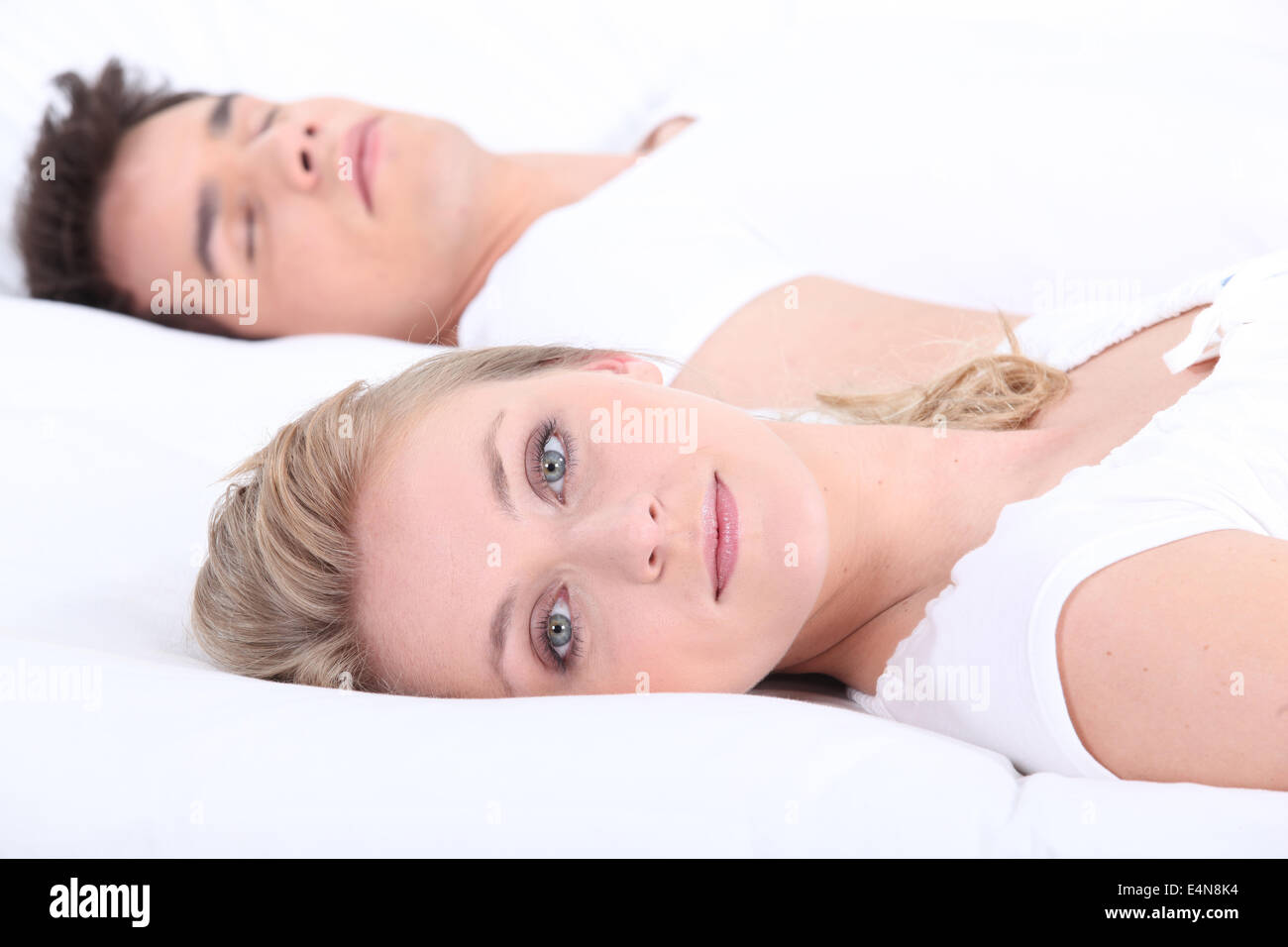 Man and woman in bed with eyes open Stock Photo