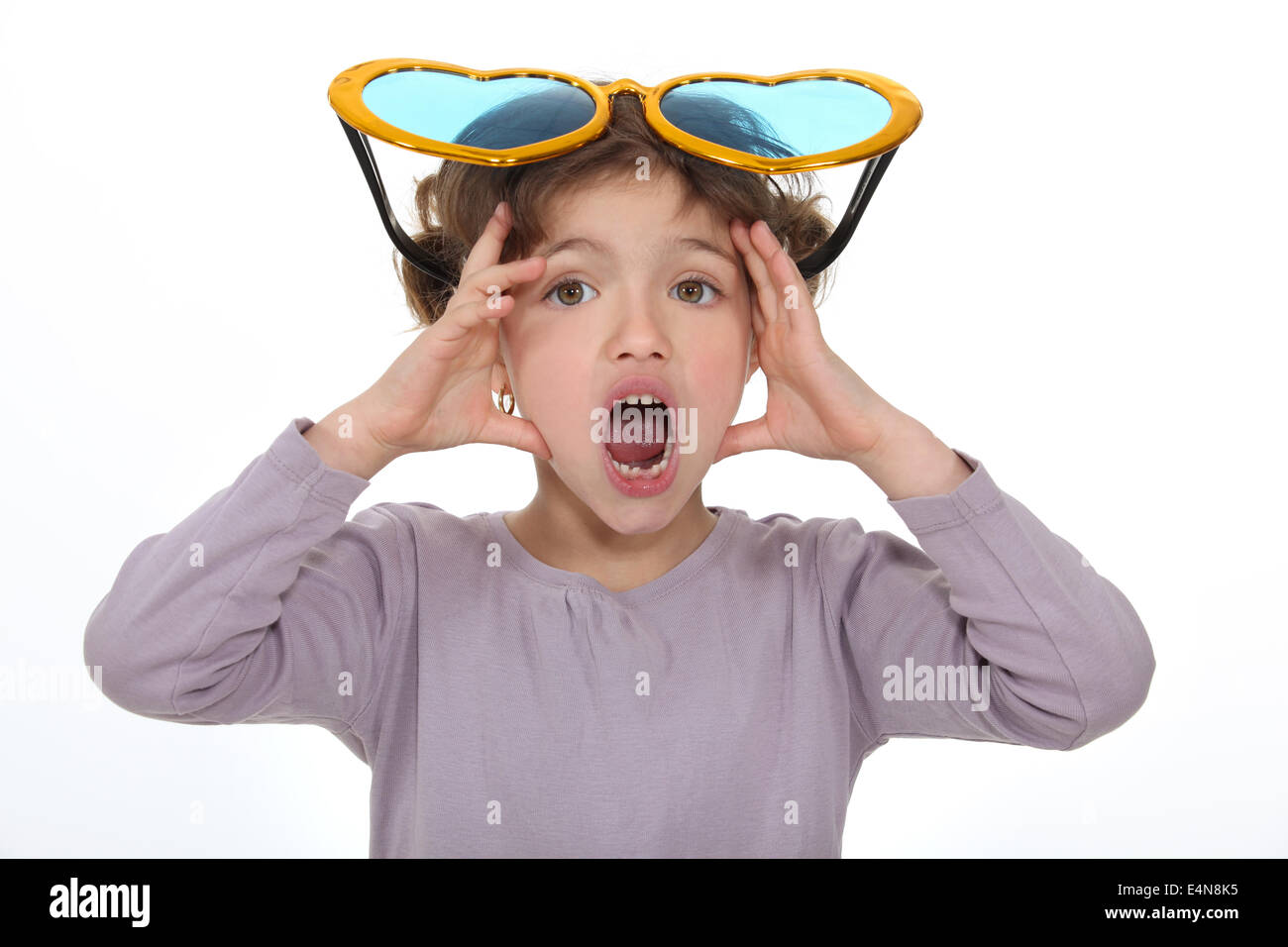Shocked little girl wearing comedy glasses Stock Photo