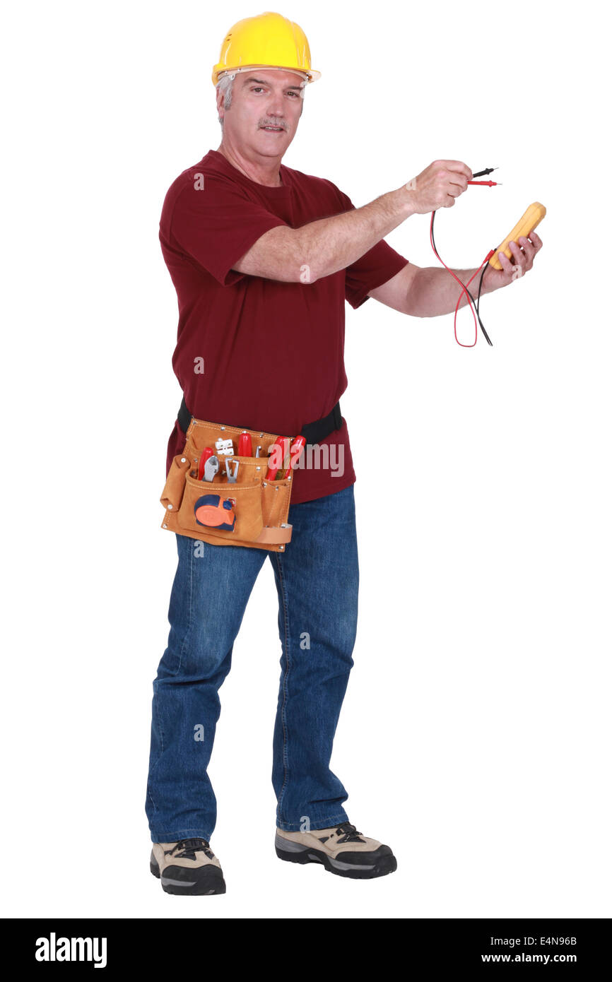 Tradesman holding a multimeter Stock Photo