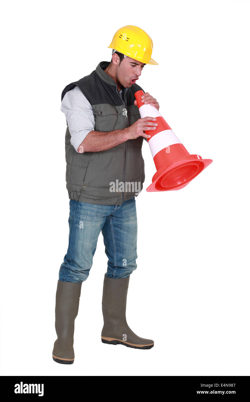 Tradesman blowing into a pylon Stock Photo