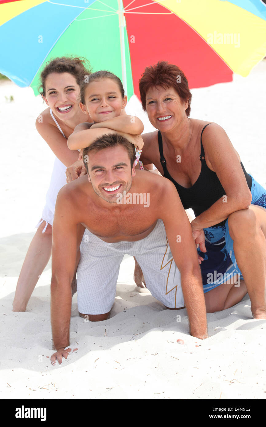 Family holidaying on a sandy beach Stock Photo