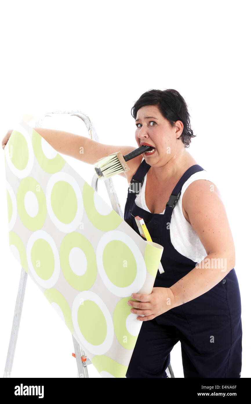Exasperated woman hanging wallpaper Stock Photo - Alamy