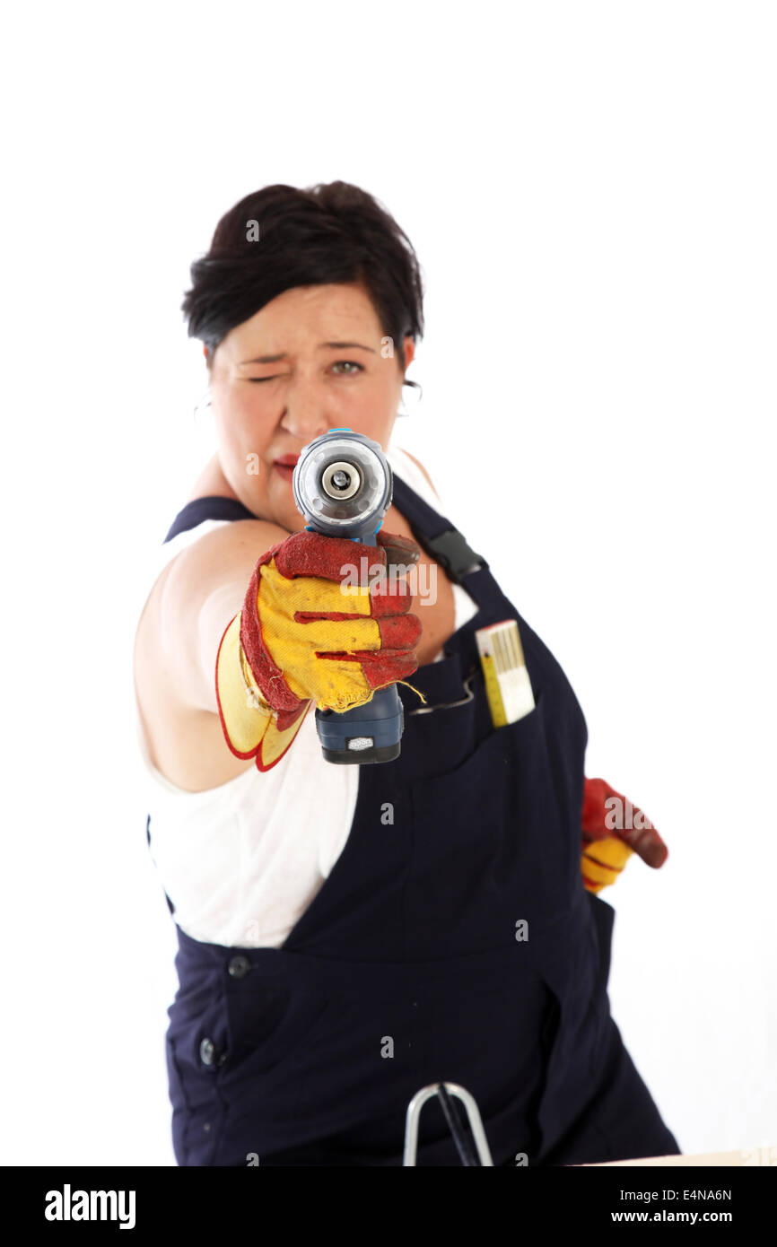 Playful woman taking aim with power drill Stock Photo