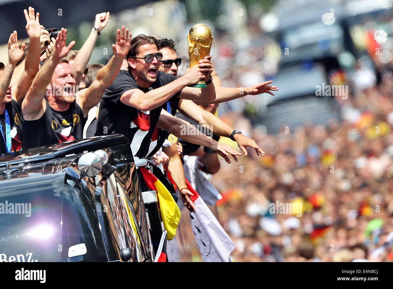 Berlin, Germany. 15th July, 2014. The players of the German national soccer team celebrate on a truck during their return to Berlin, Germany, 15 July 2014. The German team on 13 July 2014 had won the Brazil 2014 FIFA Soccer World Cup final against Argentina by 1-0 to win the title for the fourth time after 1954, 1974 and 1990. Photo: JAN WOITAS/DPA/Alamy Live News Stock Photo