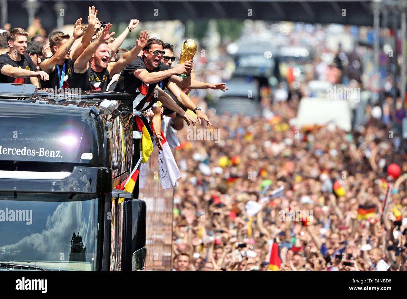 Berlin, Germany. 15th July, 2014. The players of the German national soccer team celebrate on a truck during their return to Berlin, Germany, 15 July 2014. The German team on 13 July 2014 had won the Brazil 2014 FIFA Soccer World Cup final against Argentina by 1-0 to win the title for the fourth time after 1954, 1974 and 1990. Photo: JAN WOITAS/DPA/Alamy Live News Stock Photo